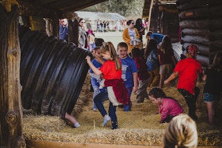 children playing in large plastic tubes
