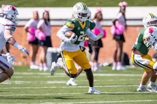 Belhaven football player running with ball