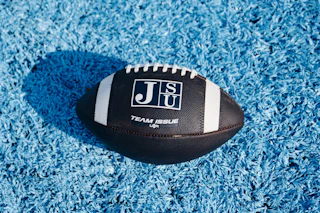 JSU football helmet on blue field