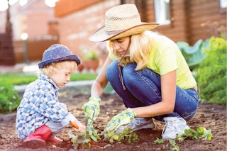a child and woman plant plants