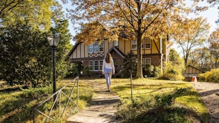 Welty house wide view with model walking toward front