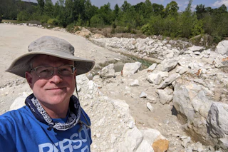 Man with rocks in the background